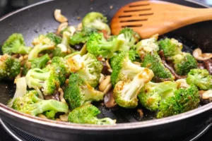 a pan with broccoli and nuts